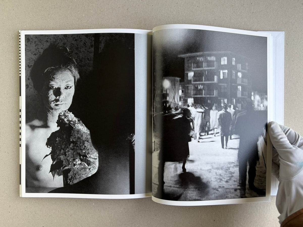 Homo Ludens open to a spread with a portrait and a street scene
