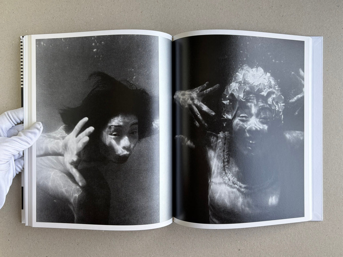 Homo Ludens open to a spread with two black-and-white portrait images