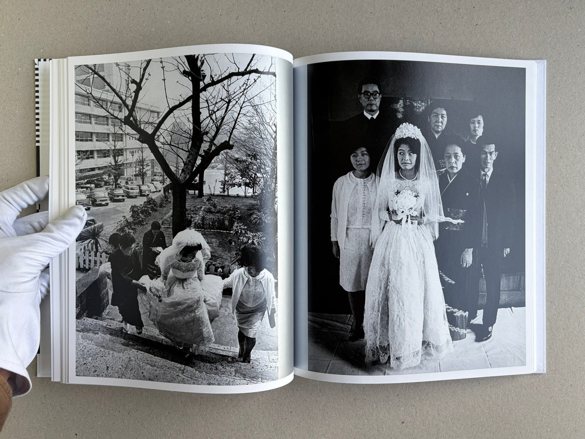Homo Ludens open to a spread with a wedding scene and group portrait in black and white