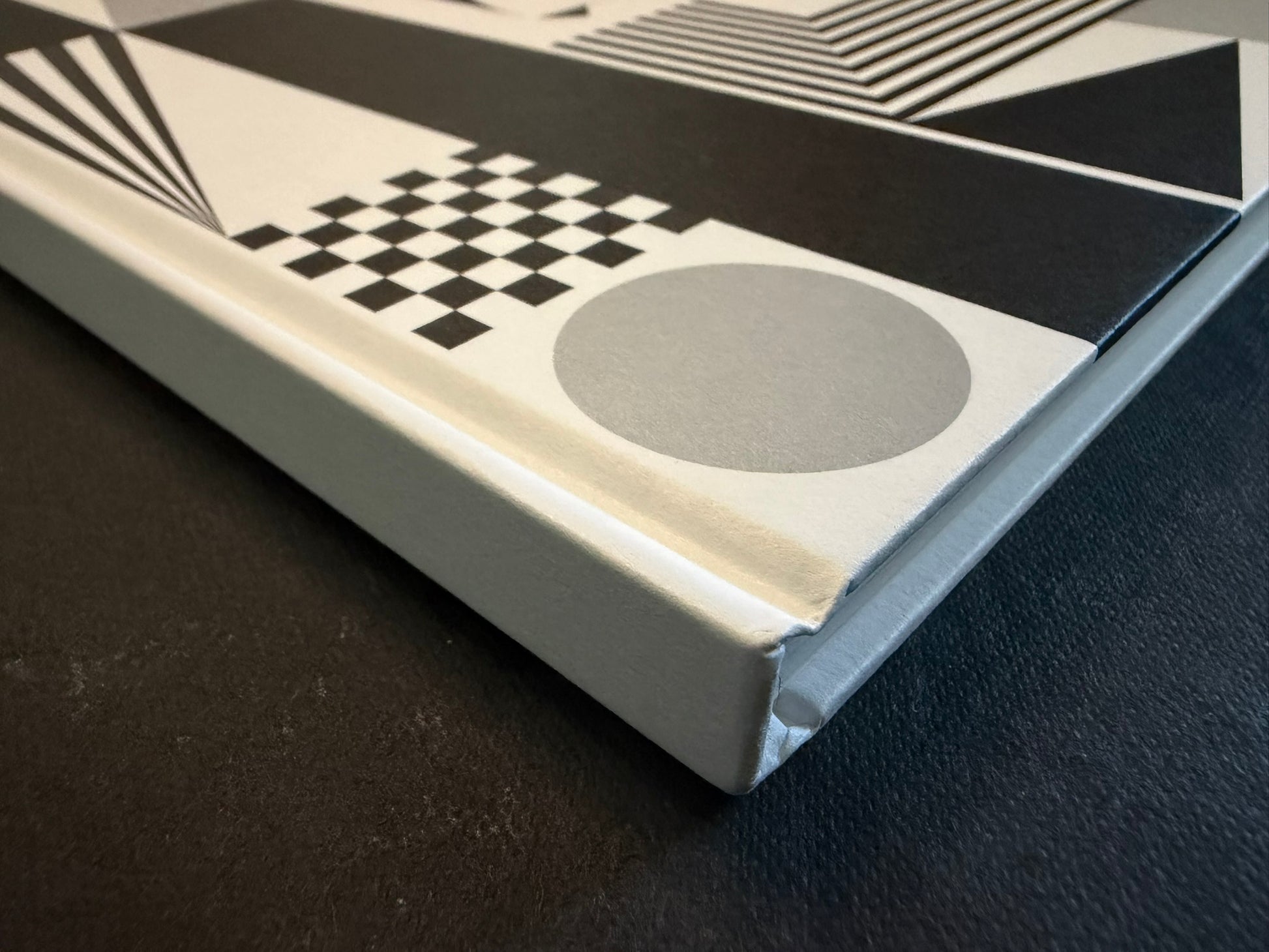 Close view of the hardcover spine and cover corner of Homo Ludens by Masahisa Fukase