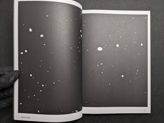 Interior spread (Trent Parke) with dark pages scattered with white specks.