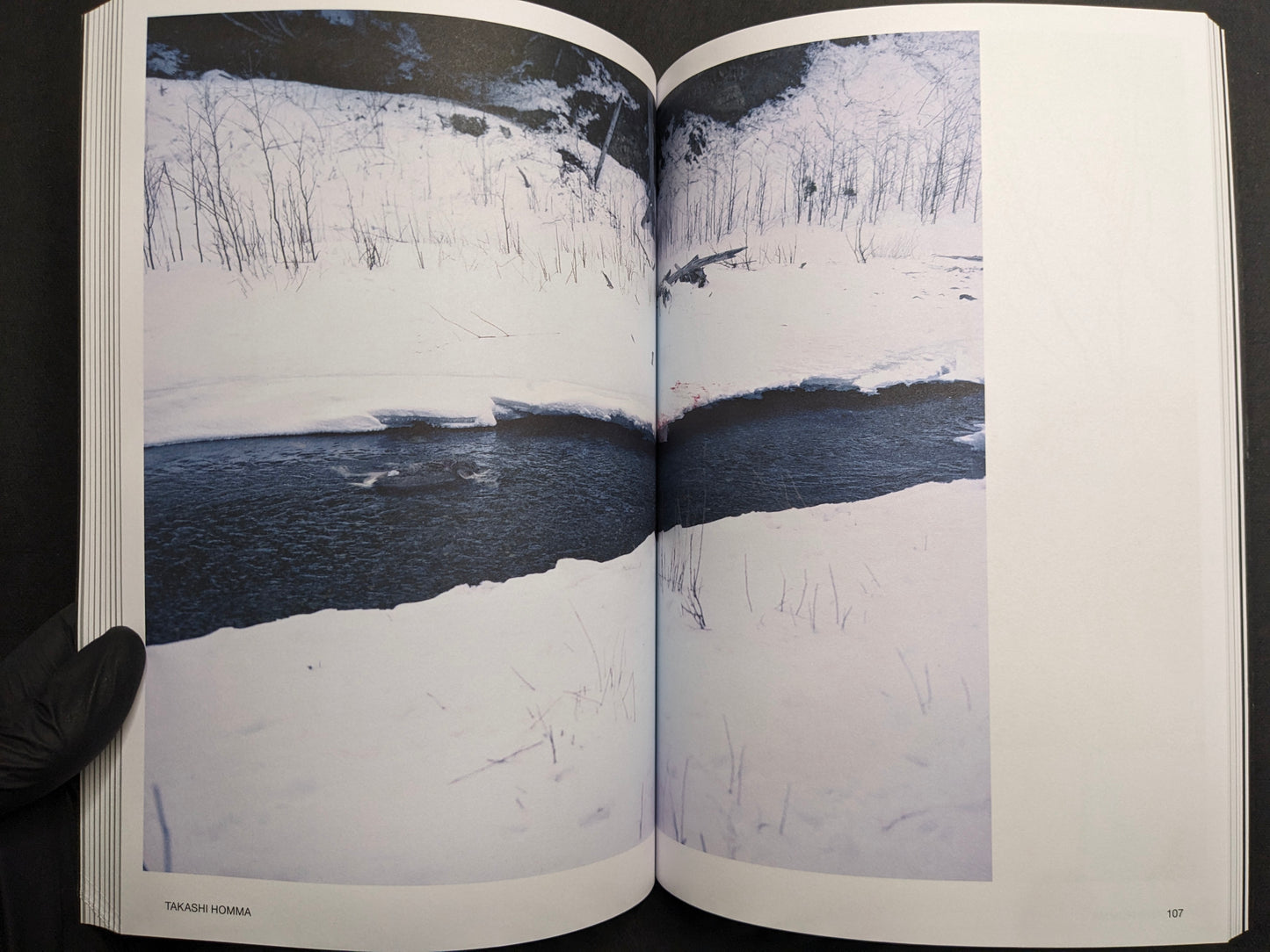Interior spread for Takashi Homma, showing a snowy river landscape.