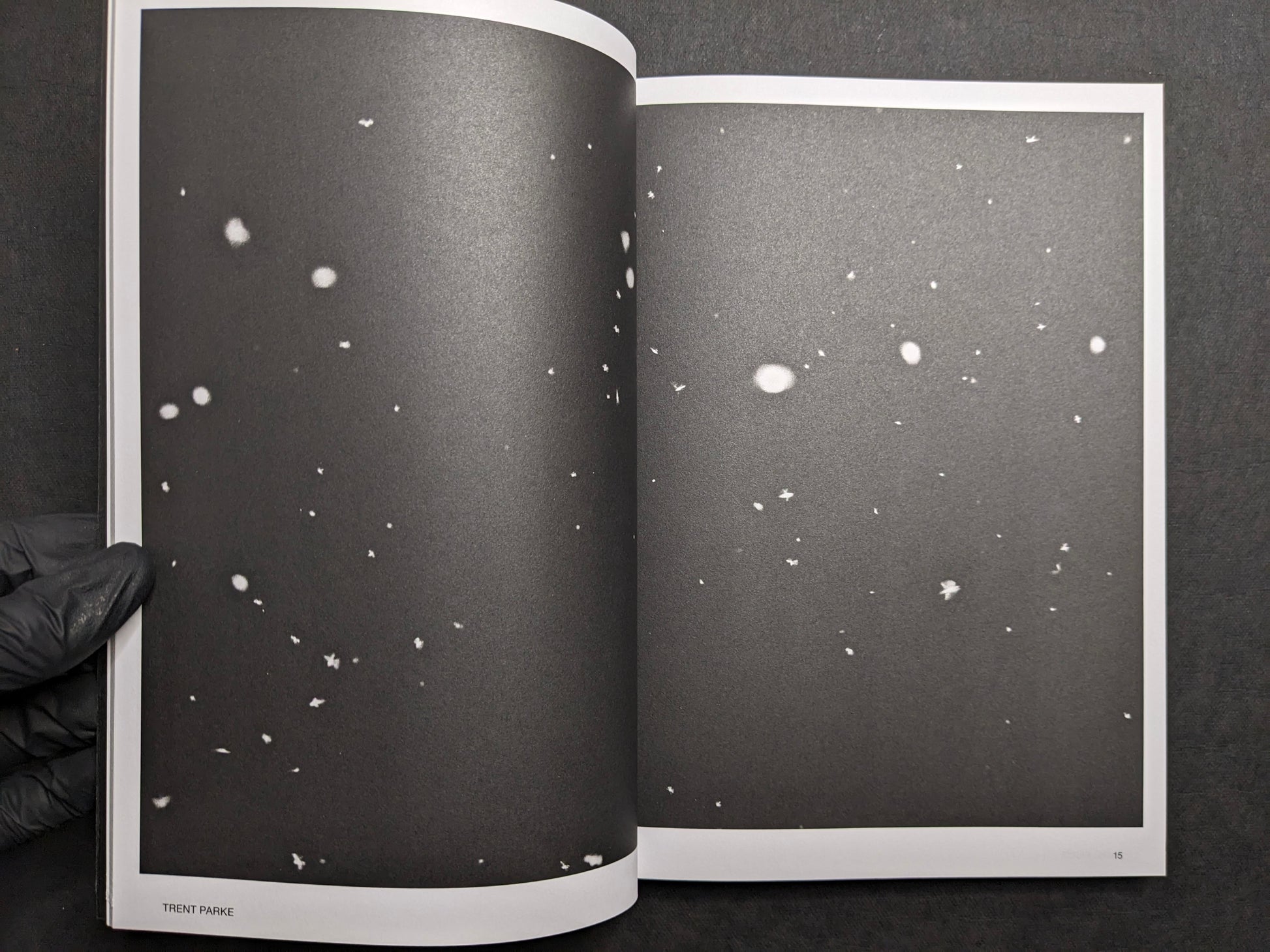 Interior spread for Trent Parke, with dark pages scattered with white specks.
