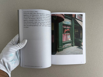 Open copy of Hotshoe Issue 214: Stephen Shore showing a text page on the left and a colour photograph of a storefront on the right