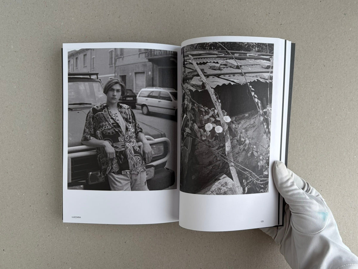 Hotshoe Issue 214: Stephen Shore open to a spread with two black-and-white photographs, held by a gloved hand.