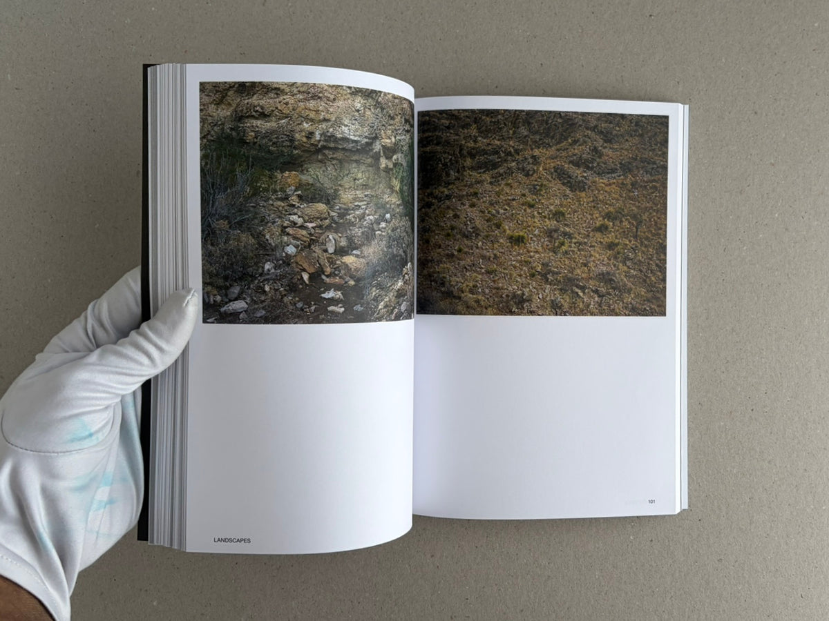Hotshoe Issue 214: Stephen Shore open to a two-page spread of landscape photographs, held by a gloved hand.