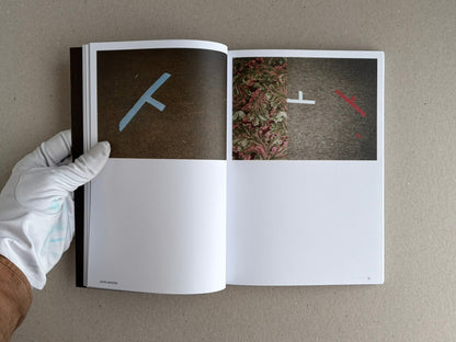 Open spread of Hotshoe Issue 215: At the Movies, showing two abstract image panels and a gloved hand holding the book open.