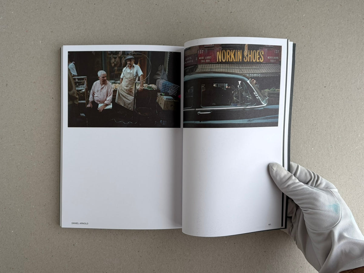 Hotshoe Issue 215: At the Movies open to a spread with two film-set photographs, one showing two men in a market stall and the other a car in front of a shop sign.