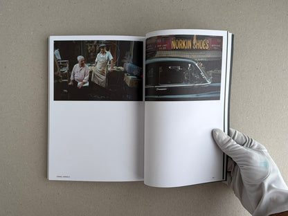 Hotshoe Issue 215: At the Movies open to a spread with two film-set photographs, one showing two men in a market stall and the other a car in front of a shop sign.