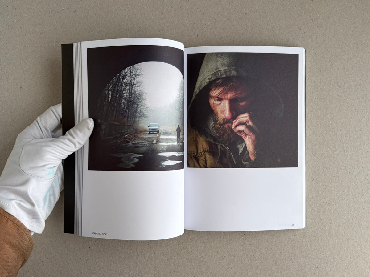 Open spread of Hotshoe Issue 215: At the Movies, showing a misty road scene on the left page and a close portrait of a hooded man on the right page, held open by a gloved hand.