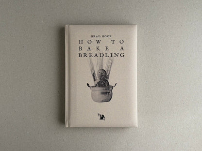 Front cover of How to Bake a Breadling by Brad Hock, showing a pale hardcover with the title and a small monochrome illustration.