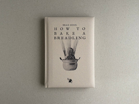Front cover of How to Bake a Breadling by Brad Hock, showing a pale hardcover with the title and a small monochrome illustration.