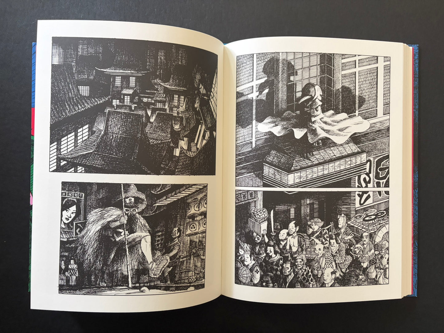 Open GariGari spread with architectural views, a seated figure in foliage, and a crowded scene in the lower right.