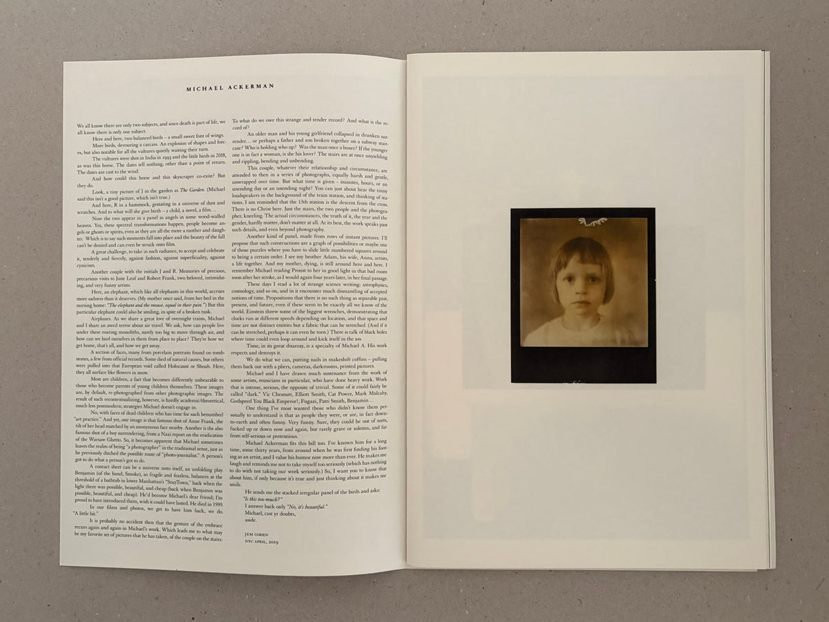 Open spread of Hunger: Epilogue by Michael Ackerman, with text on the left page and a small sepia-toned portrait image on the right page.