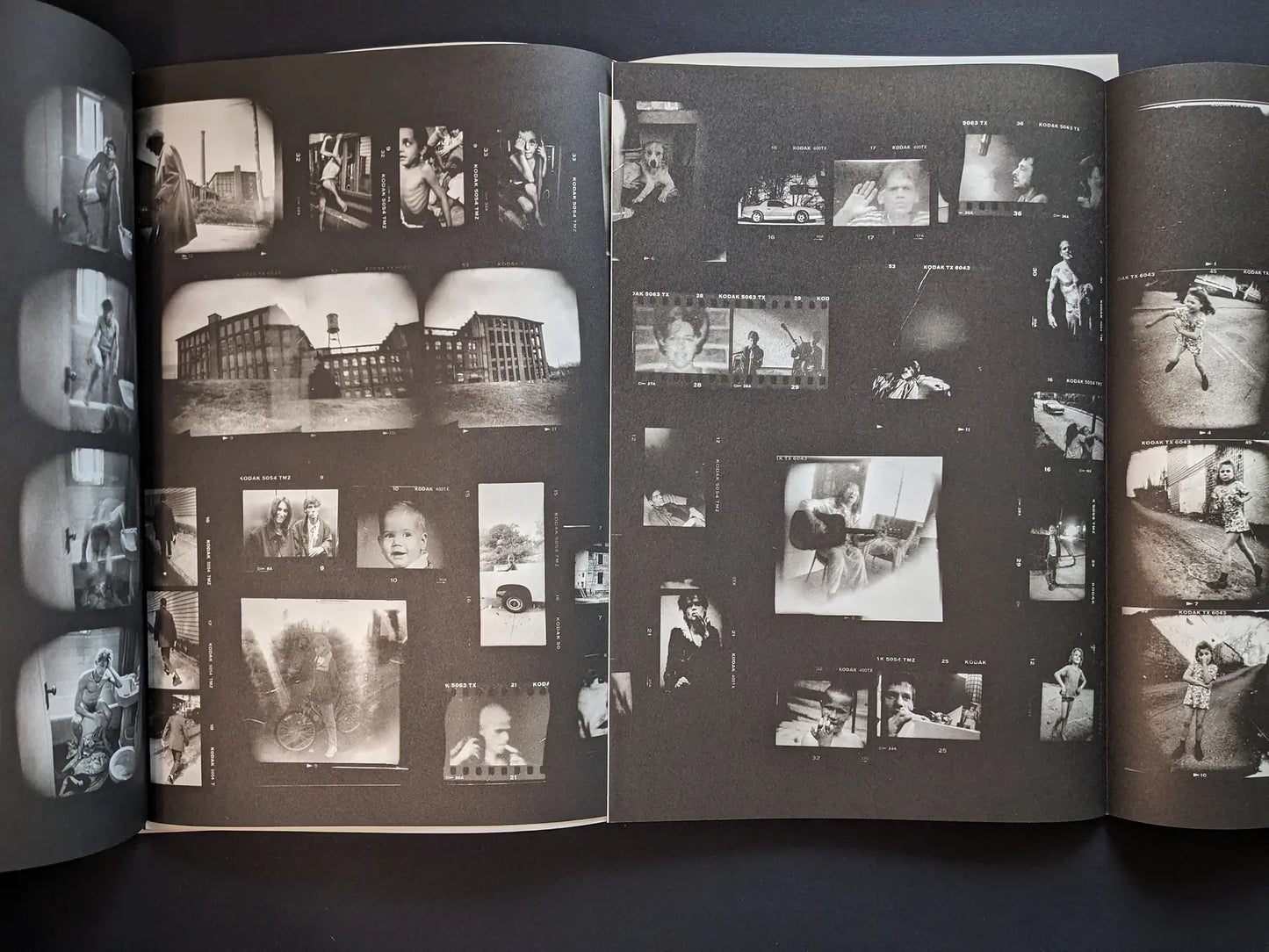 Fold-out interior from Hunger: Epilogue showing a dense contact-sheet collage of small black-and-white images of people, buildings, and streets.