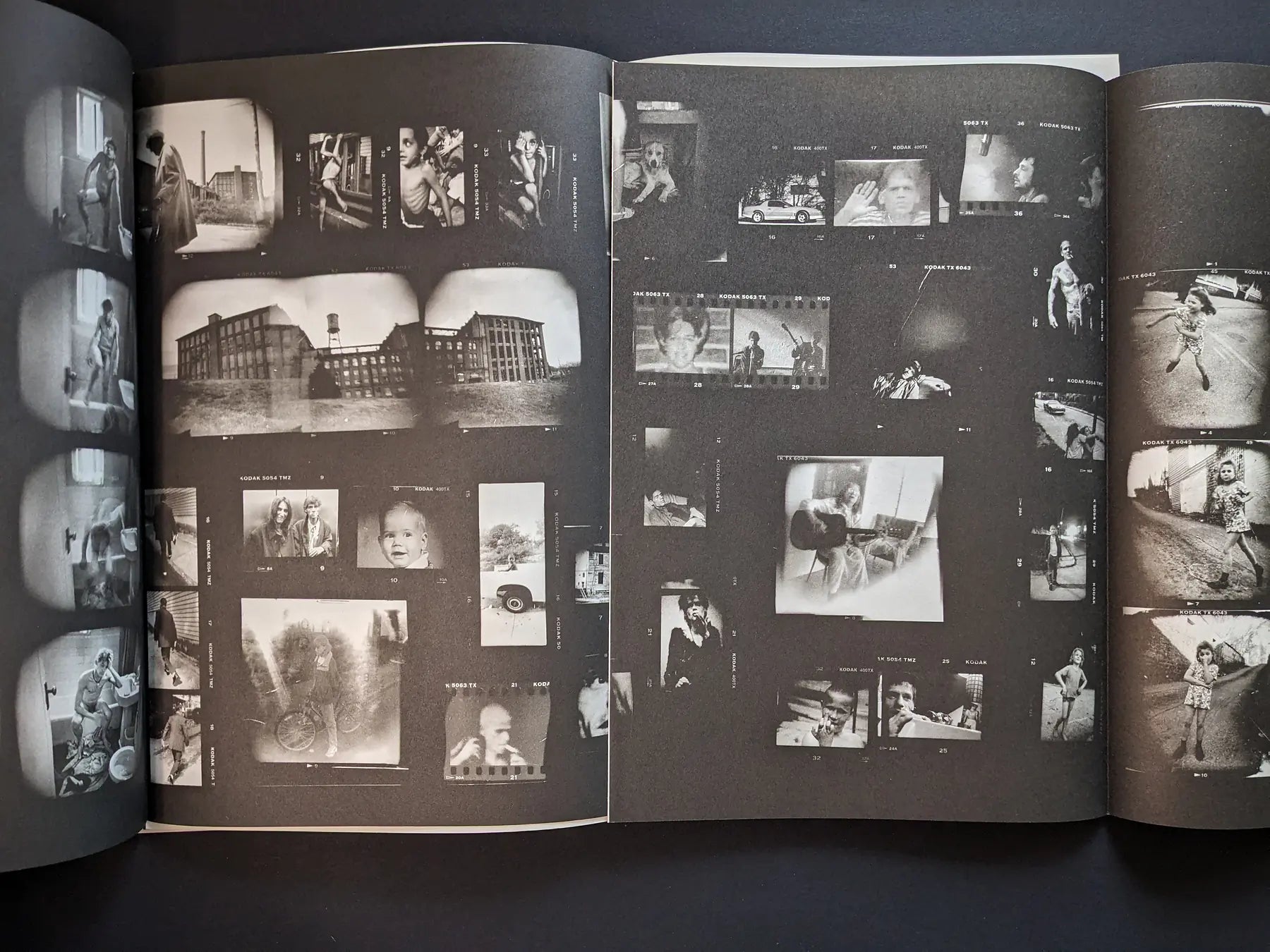 Fold-out interior from Hunger: Epilogue showing a dense contact-sheet collage of small black-and-white images of people, buildings, and streets.