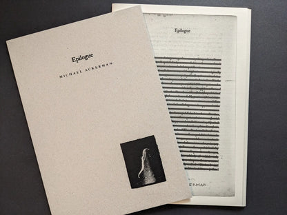 Hunger – Epilogue cover by Michael Ackerman resting on a printed insert page with heavily redacted lines of text.