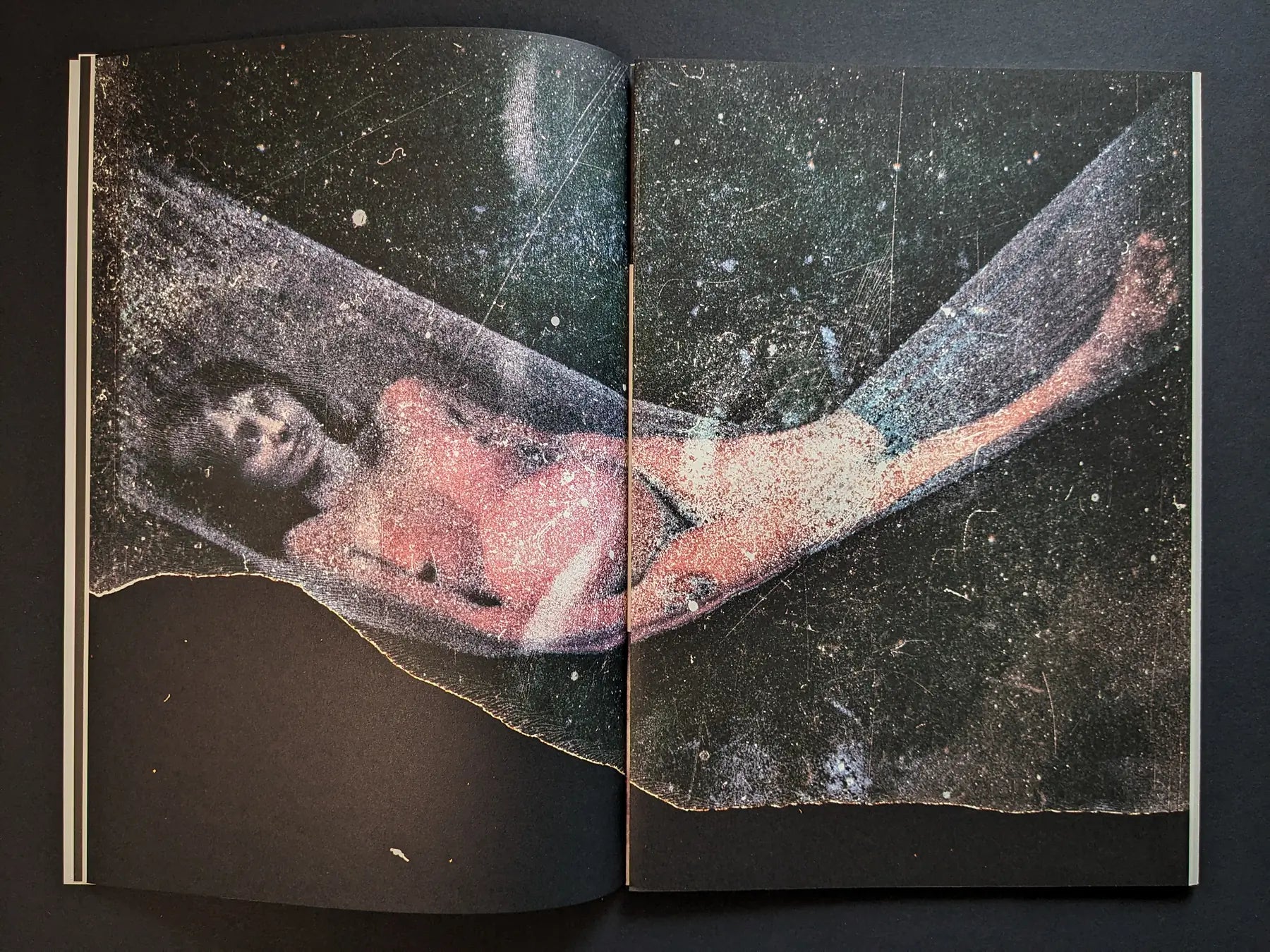 Interior spread from Hunger – Epilogue with a distressed color photograph of a woman lying in a hammock-like shape against a dark starry background.