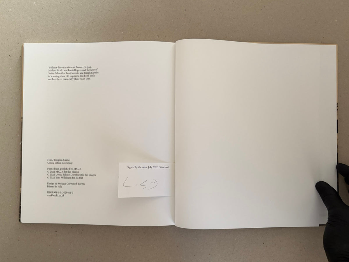 Open signed edition of Huts, Temples, Castles by Ursula Schulz-Dornburg, showing the copyright page and a signed slip bound into the back cover