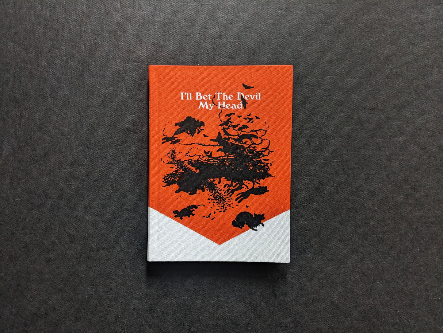 Front cover of I’ll Bet The Devil My Head by Carlos Alba (Void), orange-and-white cloth cover with black illustration.