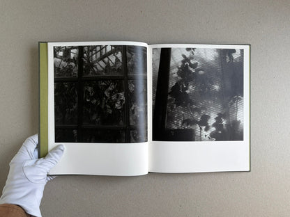 Open spread of Im Treibhaus by Takeshi Shinoda, showing two black-and-white greenhouse photographs on facing pages.