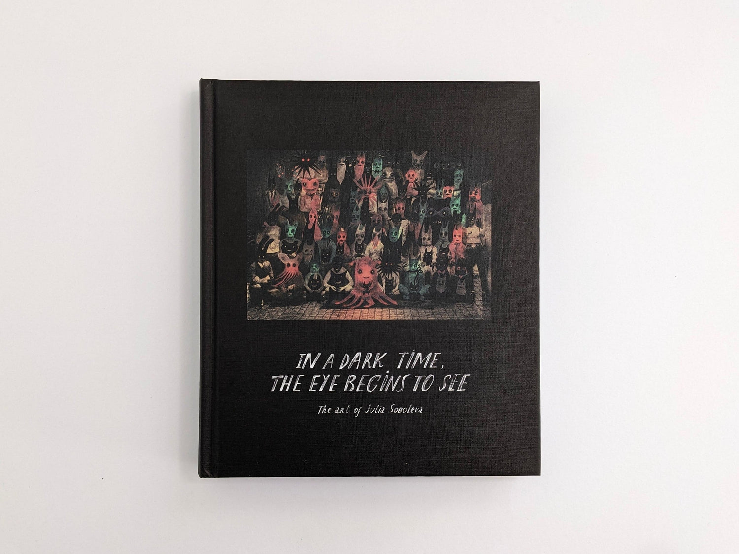 Front cover of In a Dark Time, the Eye Begins to See by Julia Soboleva, black clothbound hardcover with a group portrait illustration.