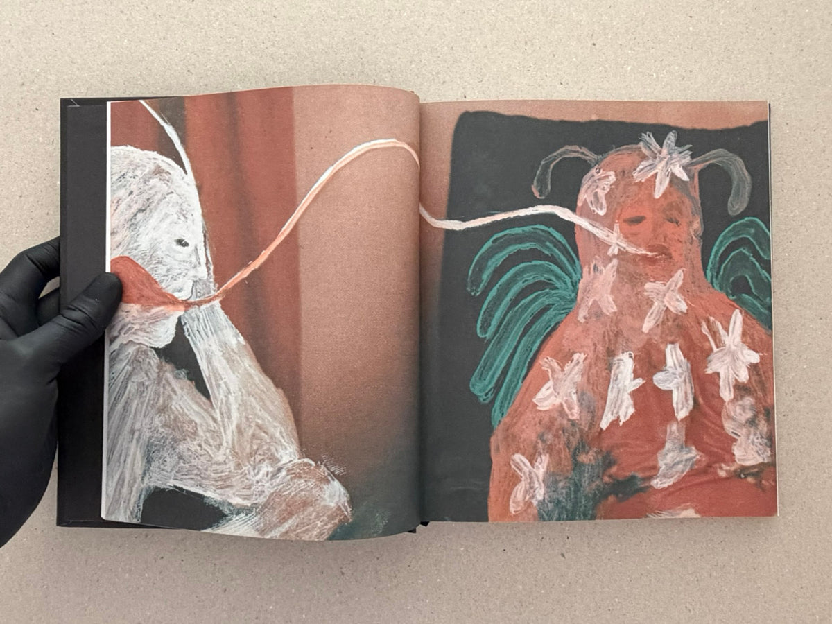 Open artbook spread from In a Dark Time, the Eye Begins to See – The Art of Julia Soboleva, showing two mixed-media figures painted over found imagery.