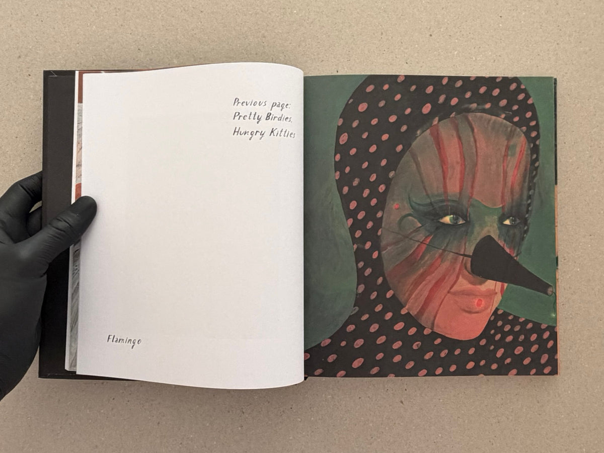 Open artbook spread from In a Dark Time, the Eye Begins to See – The Art of Julia Soboleva, showing a mostly blank left page with handwritten text and a collage portrait on the right page.