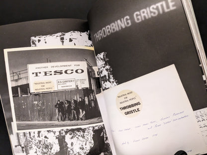 Archive spread with Throbbing Gristle sticker and photo by Chris Carter at a Tesco construction site.