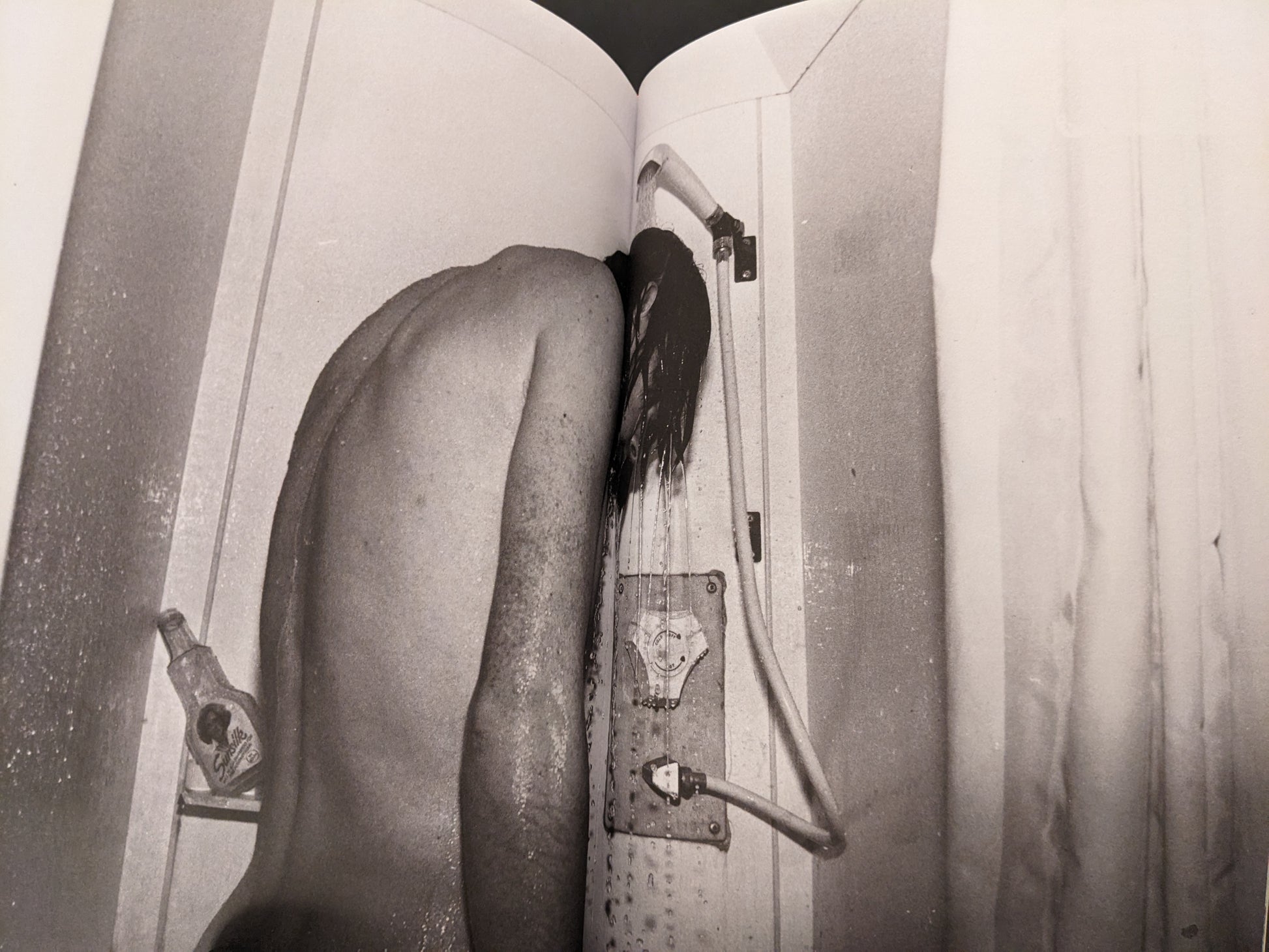 Black-and-white photograph of a person showering, from the concluding section of In Steel Grey Armour.
