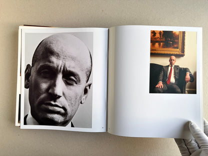 Open Index — Christopher Anderson booklet with a close-up of a face on the left and a seated figure in a teal jacket on the right.