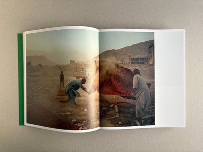 Open Index — Christopher Anderson booklet with a colour spread of a meal tray and a man holding fruit in a kitchen.