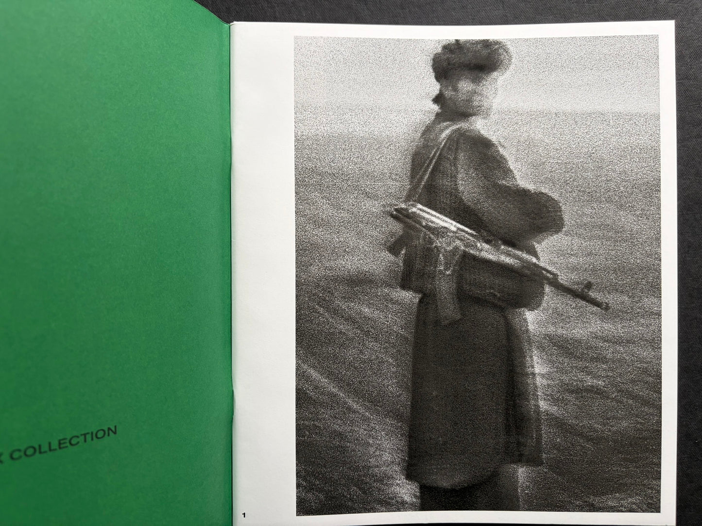 Index by Christopher Anderson, open volume with a black-and-white photograph on the right page and a green endpaper on the left.