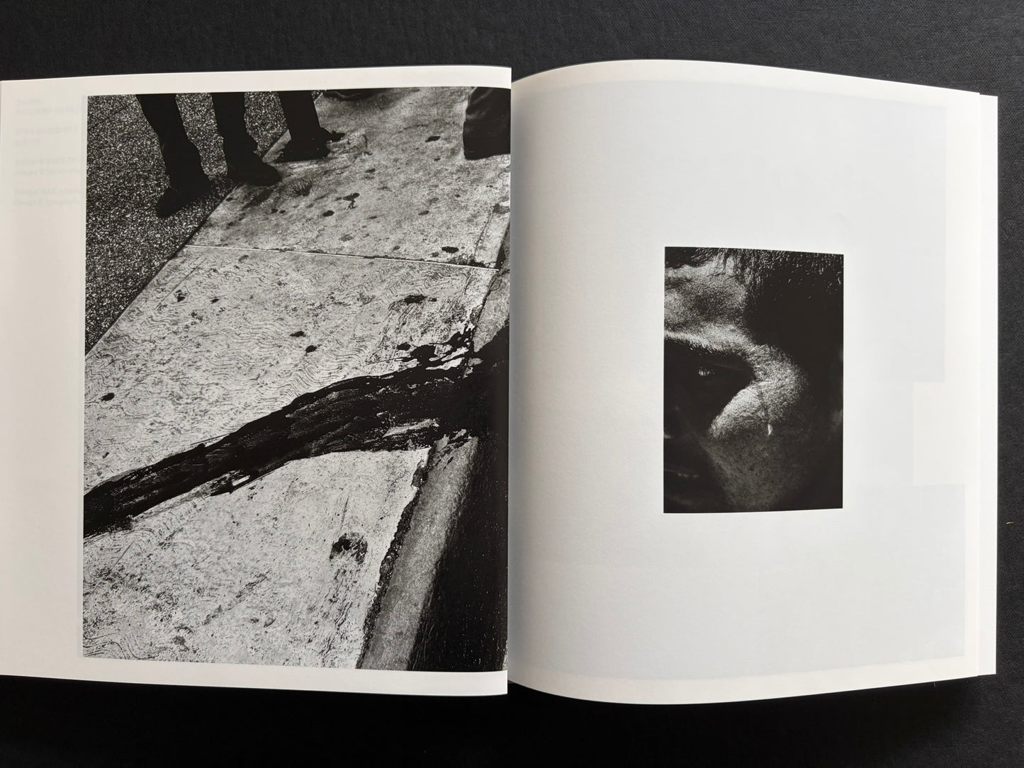 Index by Christopher Anderson, black-and-white spread with a street detail on the left and a cropped face on the right.