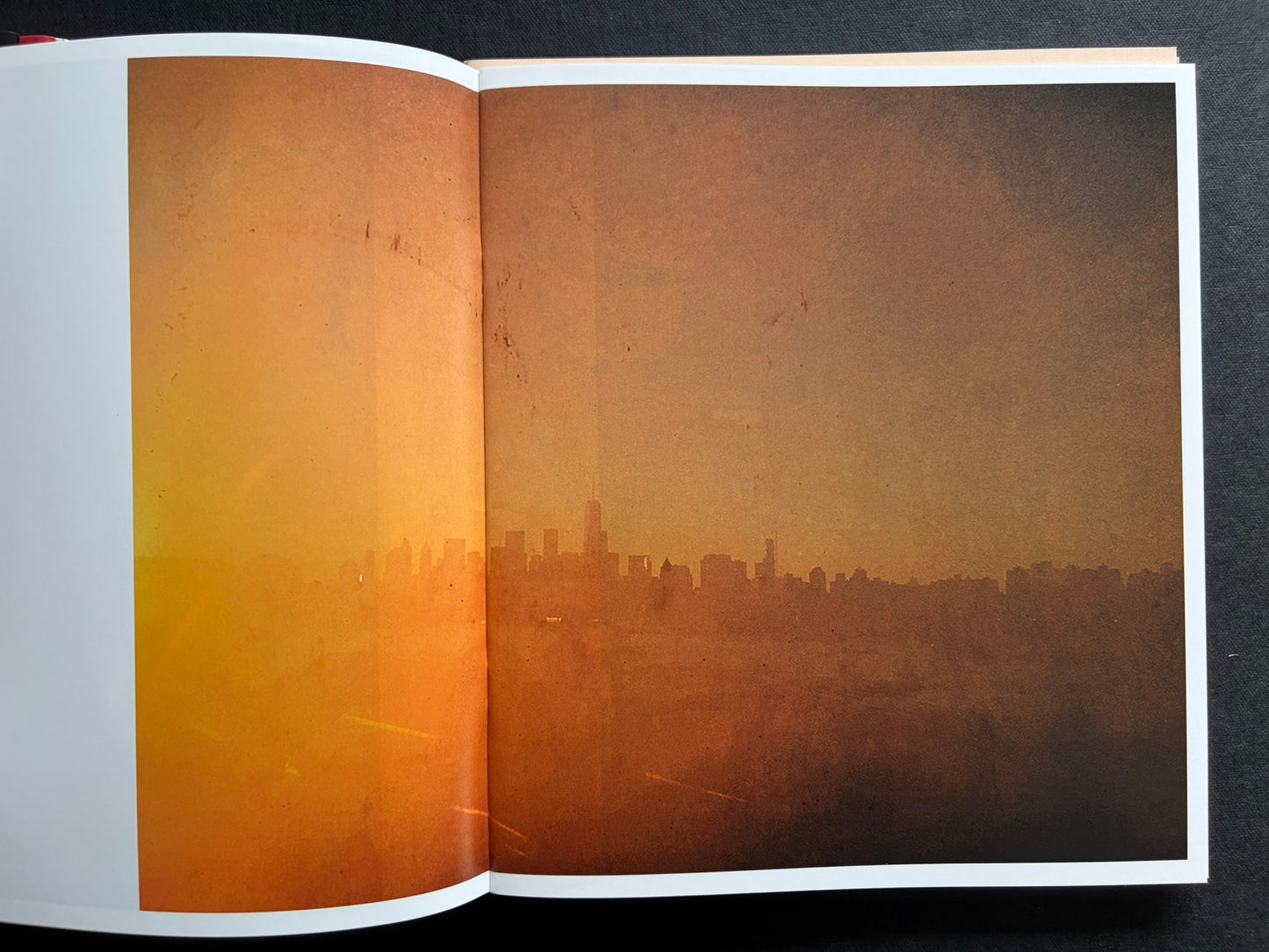 Index by Christopher Anderson, spread with a warm orange skyline image across both pages.