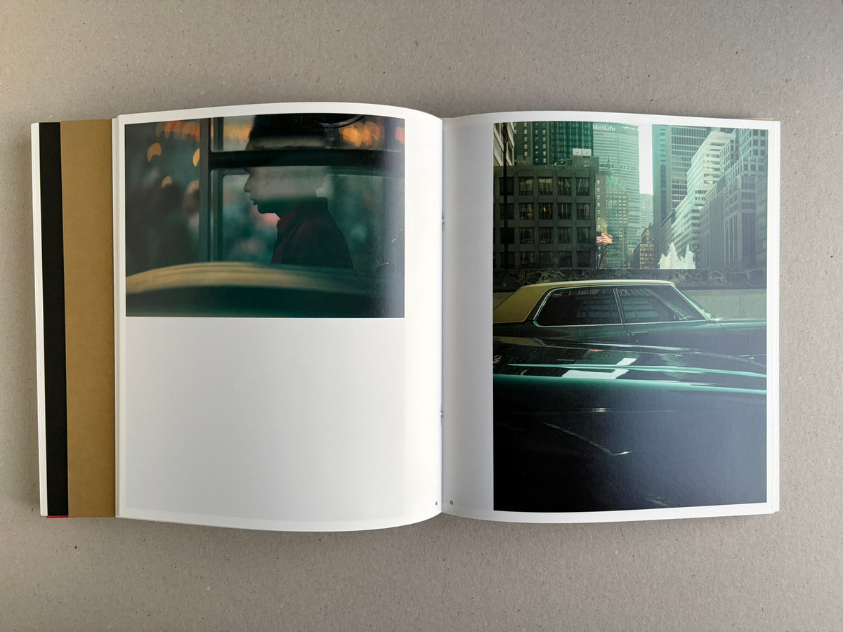 Open Index — Christopher Anderson booklet with a colour spread of a person in a red coat, a man by a wall, and layered images on the left page.