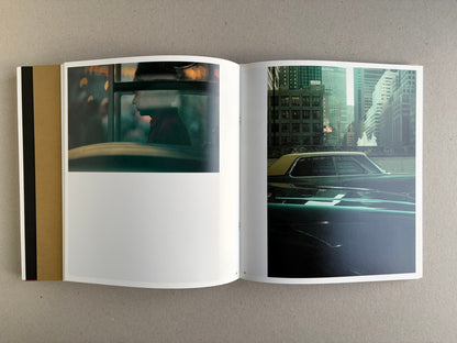 Open Index — Christopher Anderson booklet with a colour spread of a person in a red coat, a man by a wall, and layered images on the left page.