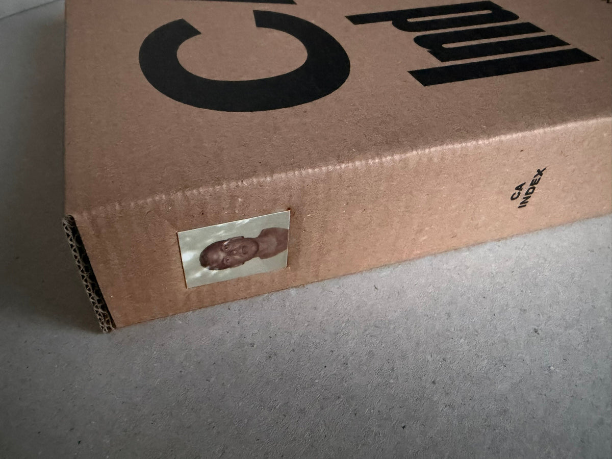 Close view of the Index — Christopher Anderson slipcase corner, showing cardboard construction and a small label.