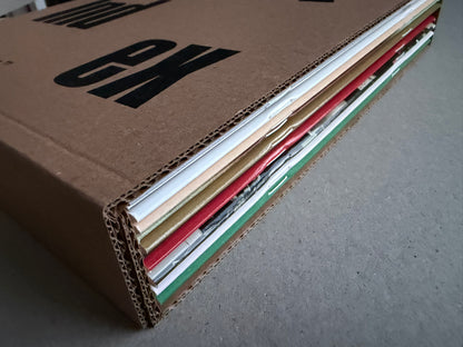 Index — Christopher Anderson slipcase edge, showing stacked booklet spines and exposed cardboard layers.