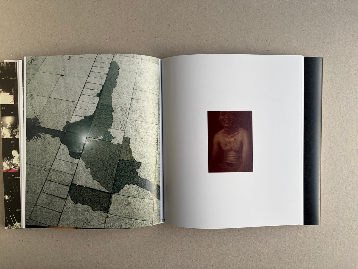 Open Index — Christopher Anderson booklet with a tiled floor detail on the left and a small portrait on the right.