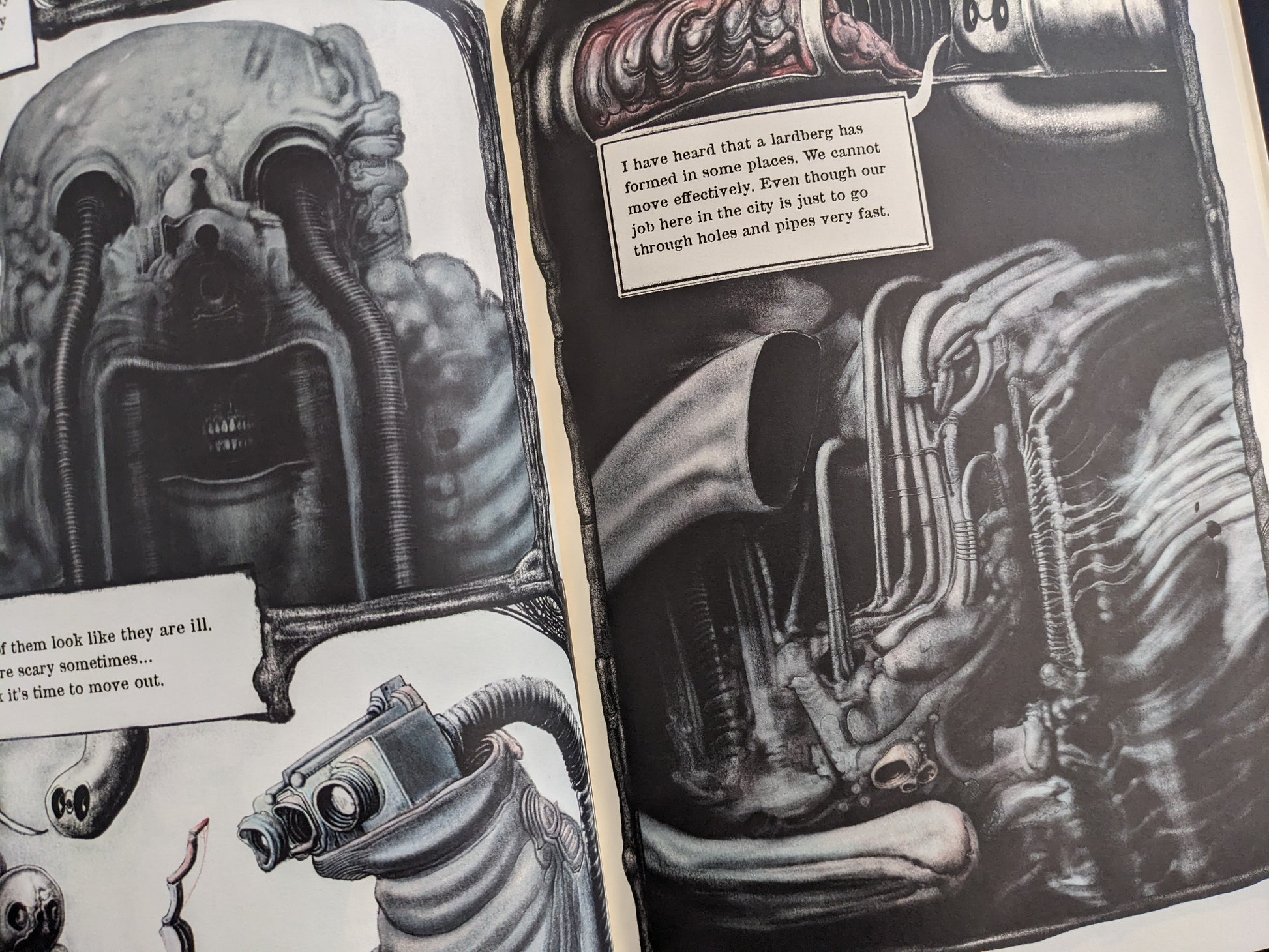 Open spread with a skull-like face, a dog figure, and dense biomechanical textures in black and white.