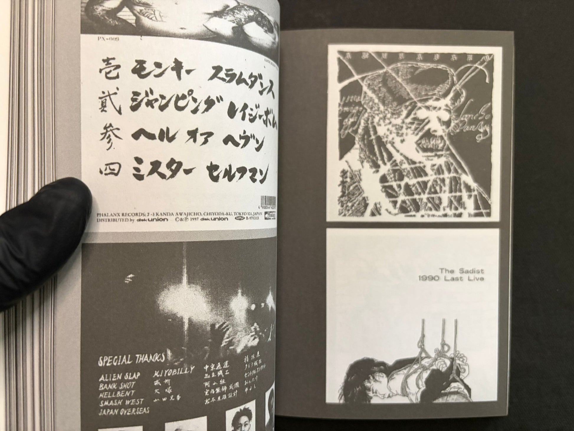Interior spread of Japanese Punk Graphics (1980–2010) with Japanese text, a skull-like drawing, and a cartoon dog guitarist