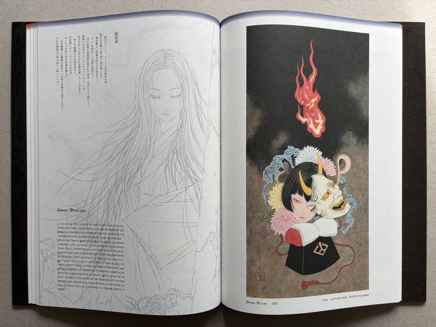 Japonesthétique by Takato Yamamoto opened to a text page and a demon mask illustration.