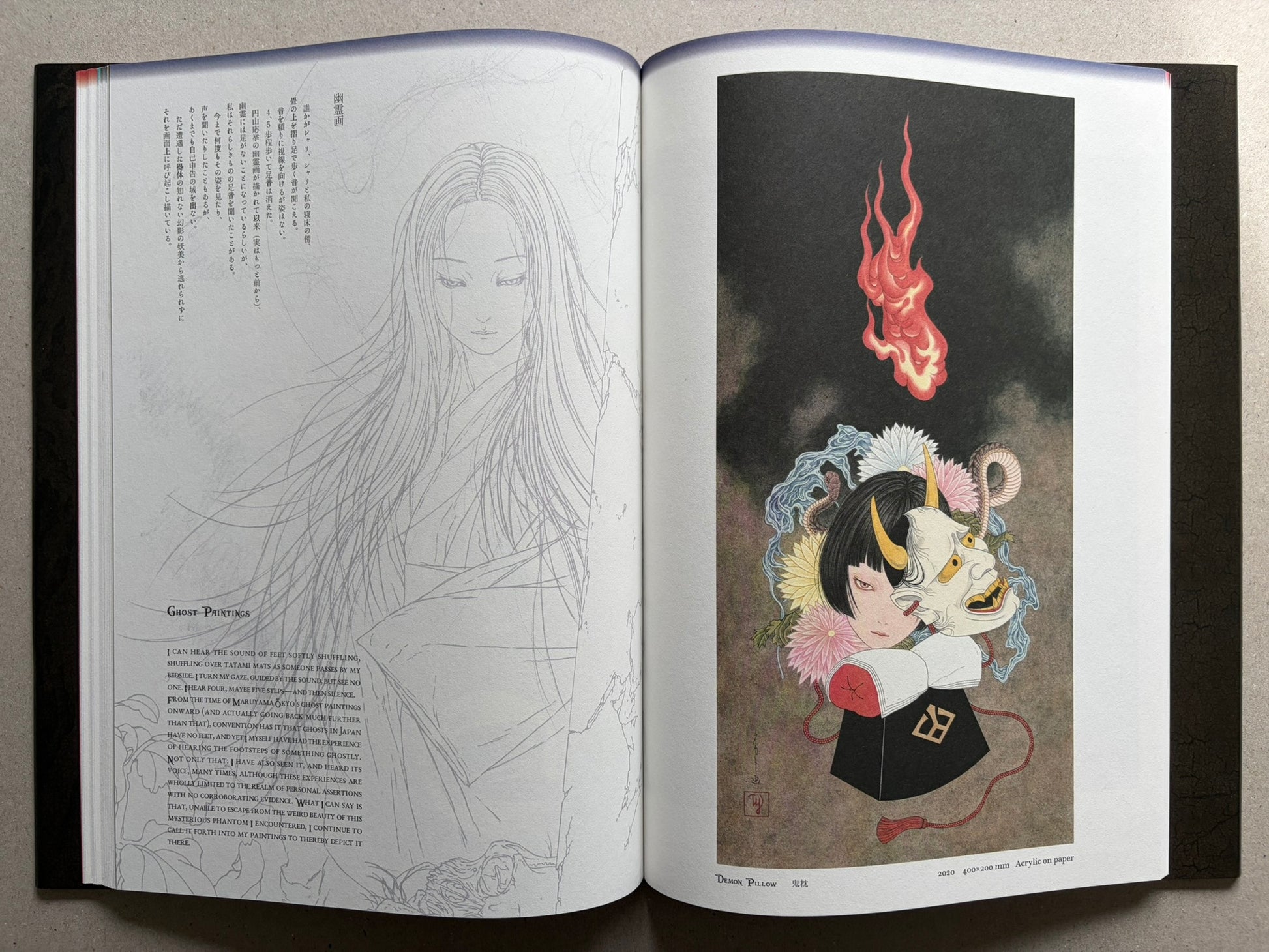 Japonesthétique by Takato Yamamoto opened to a text page and a demon mask illustration.