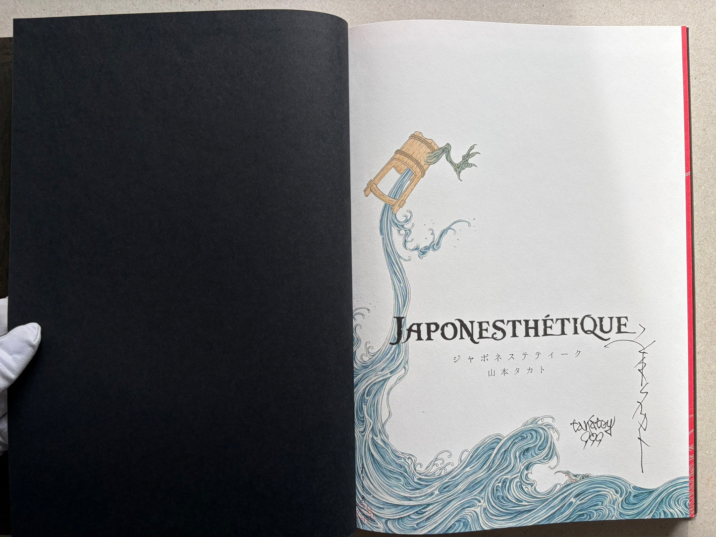 Japonesthétique by Takato Yamamoto opened to a title page with a signed inscription and wave illustration.