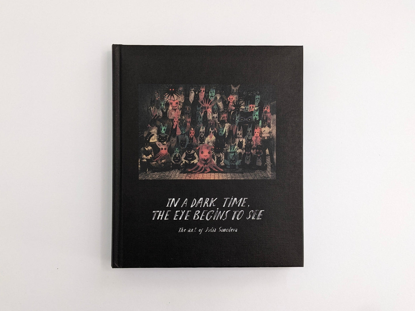 Front cover of “In a Dark Time, the Eye Begins to See: The Art of Julia Soboleva” (The Mansion Press), black clothbound hardcover with a group portrait illustration.