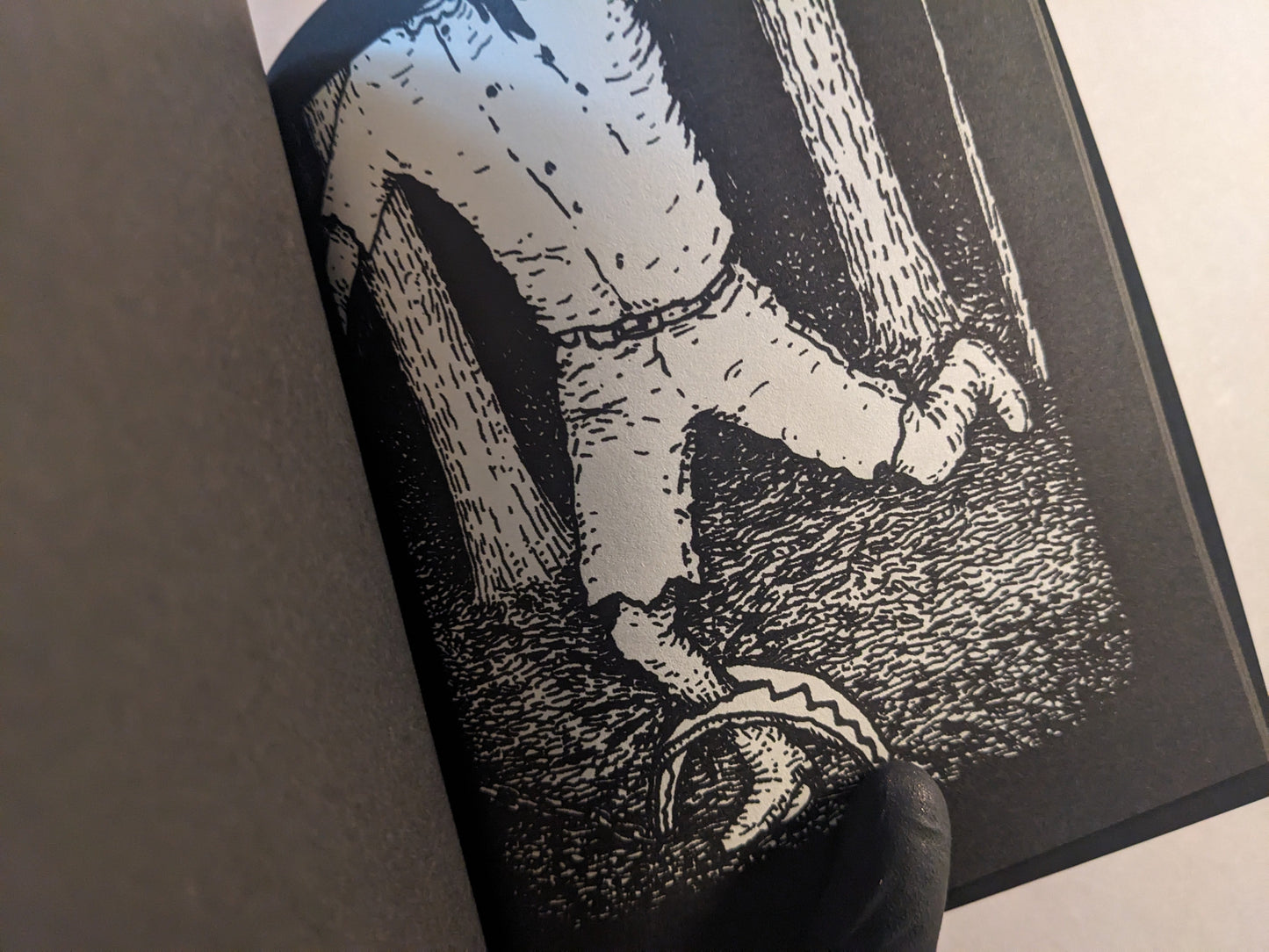 Interior page with a figure trapped in a dark forest, rendered in black and white.