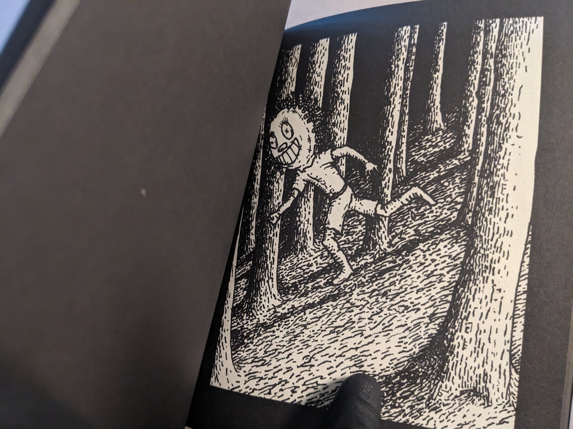Interior illustration of a grinning character in a forest, in black and white.