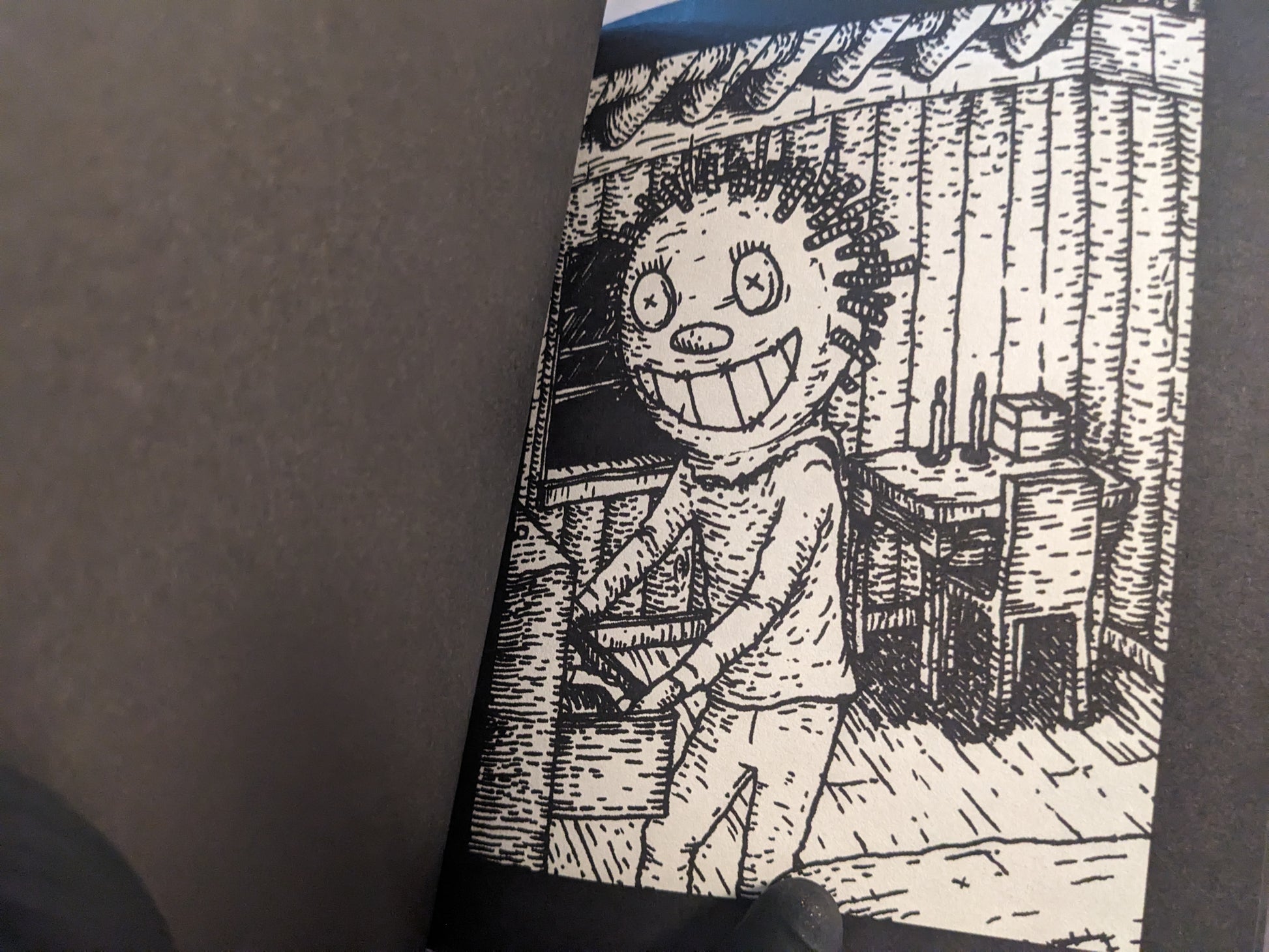 Interior artwork showing a grinning figure inside a wooden cabin.