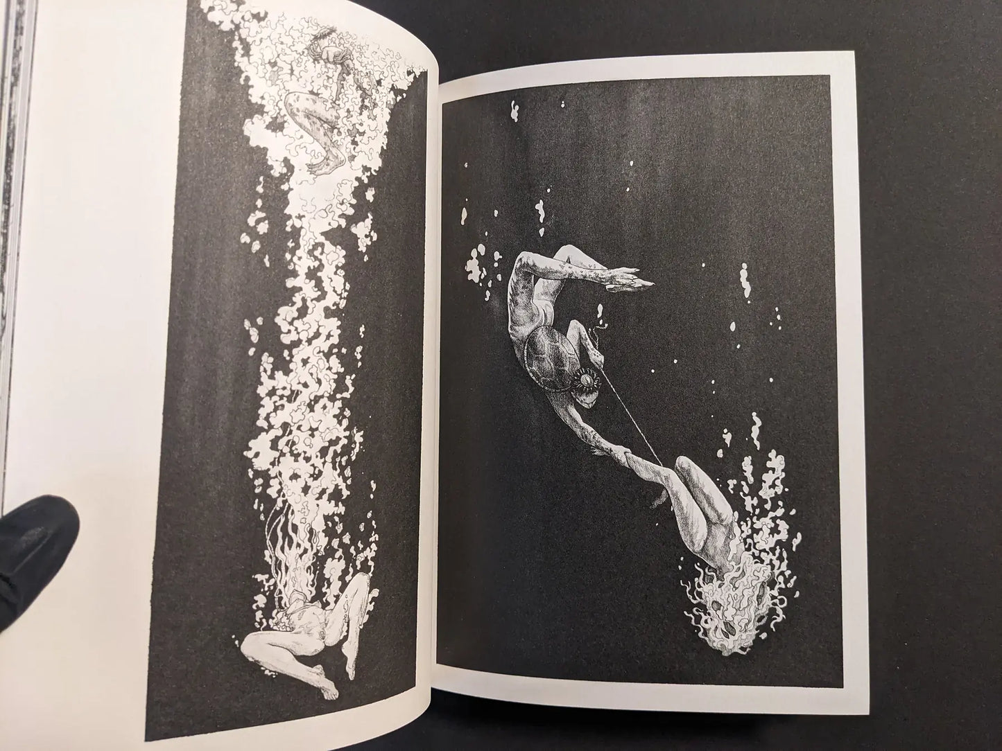 Interior spread with underwater figures and rising bubbles, black-and-white ink